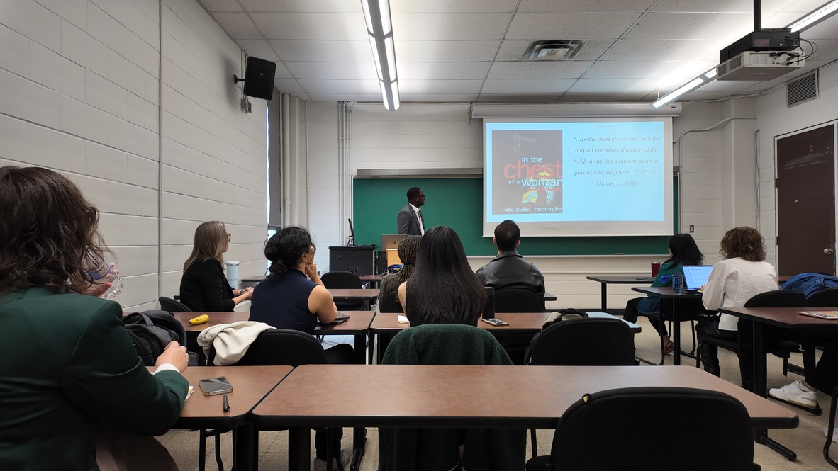 A lab member presenting to delegates during a conference session